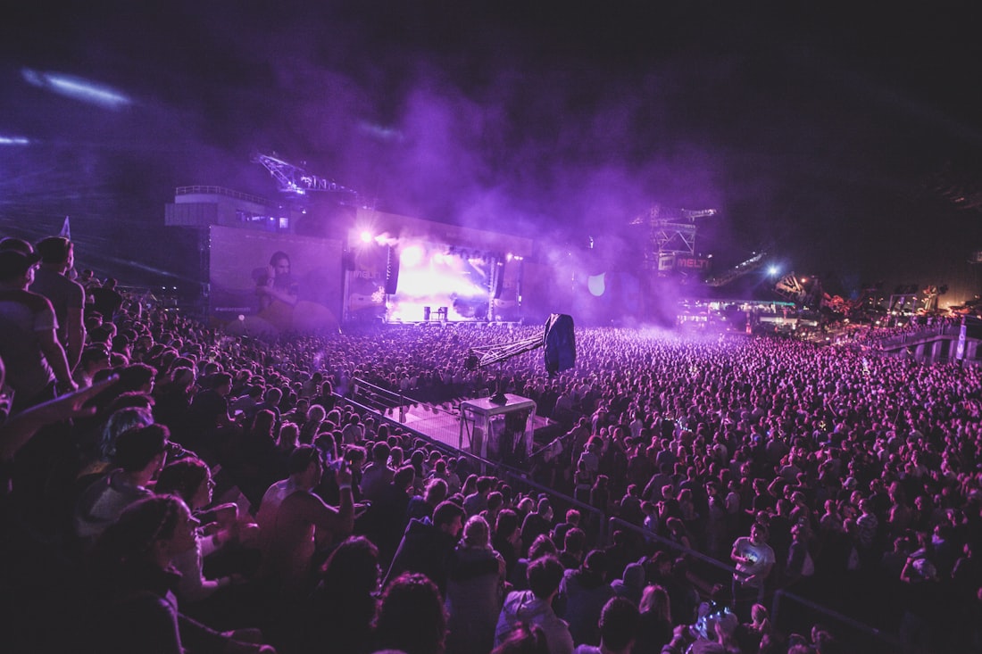 Audience gathered in front of a warm stage wash.